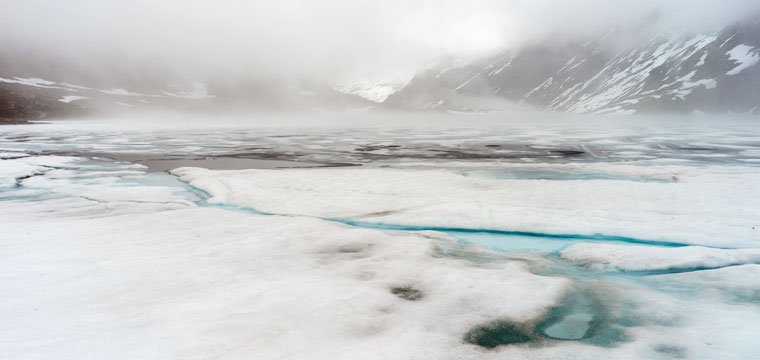 Partially frozen lake in the mountains 